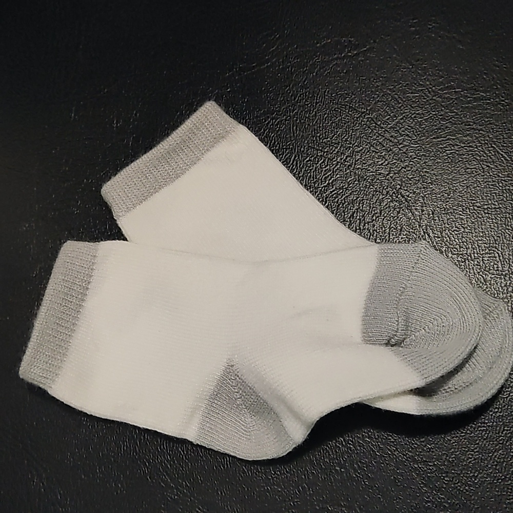 White infant socks with grey at heel and toes
